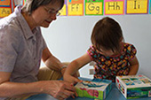 Louise and girl activity in Open Door Ministry